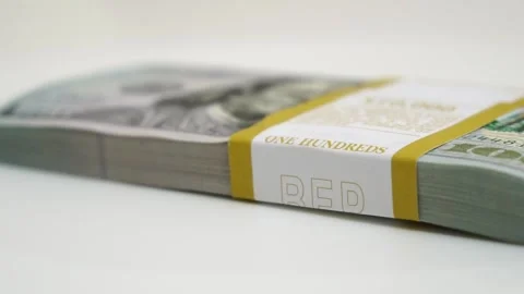 Stack of bank bundles with US dollars on a white background. Close-up shot of Stock Footage 242986934
