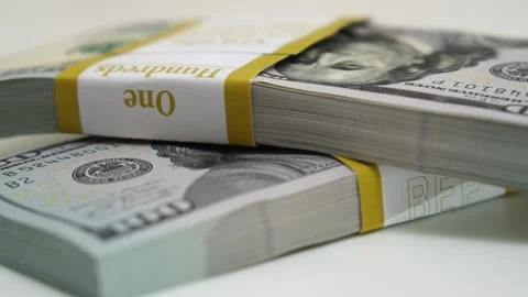Stack of bank bundles with US dollars on a white background. Close-up shot of Stock Footage 243078160