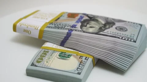 Stack of bank bundles with US dollars on a white background. Close-up shot of Stock Footage 243173050