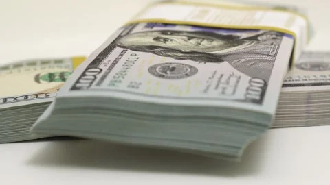 Stack of bank bundles with US dollars on a white background. Close-up shot of Stock Footage 243258759