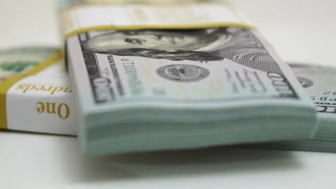 Stack of bank bundles with US dollars on a white background. Close-up shot of Stock Footage 243638161