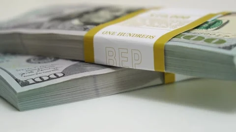 Stack of bank bundles with US dollars on a white background. Close-up shot of Stock Footage 243713491