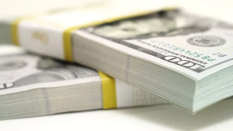 Stack of bank bundles with US dollars on a white background. Close-up shot of Stock Footage 243888364