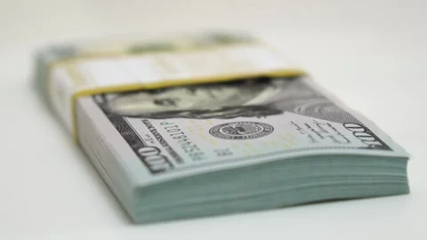 Stack of bank bundles with US dollars on a white background. Close-up shot of Stock Footage 243970763
