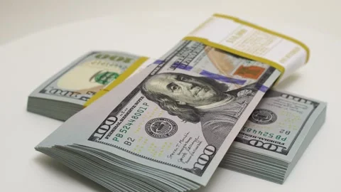 Stack of bank bundles with US dollars on a white background. Close-up shot of Stock Footage 244302838