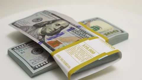 Stack of bank bundles with US dollars on a white background. Close-up shot of Stock Footage 244452592