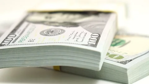 Stack of bank bundles with US dollars on a white background. Close-up shot of Stock Footage 244572509