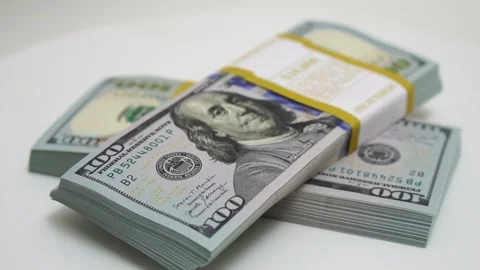 Stack of bank bundles with US dollars on a white background. Close-up shot of Stock Footage 244702229
