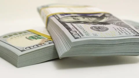 Stack of bank bundles with US dollars on a white background. Close-up shot of Stock Footage 244772547