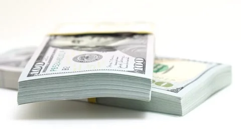 Stack of bank bundles with US dollars on a white background. Close-up shot of Stock Footage 244835594