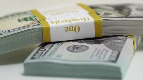 Stack of bank bundles with US dollars on a white background. Close-up shot of Stock Footage 244979606