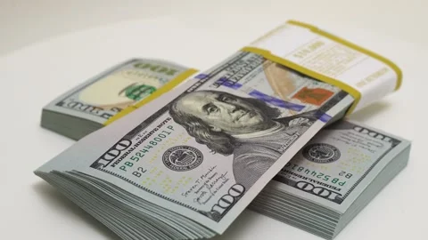 Stack of bank bundles with US dollars on a white background. Close-up shot of Stock Footage 245145694