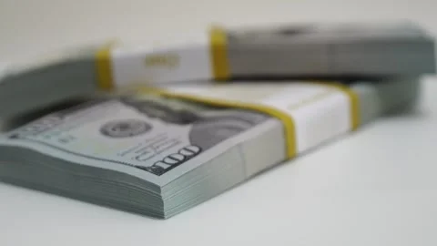 Stack of bank bundles with US dollars on a white background. Close-up shot of Stock Footage 245416539