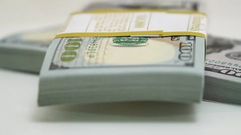 Stack of bank bundles with US dollars on a white background. Close-up shot of Stock Footage 245478600