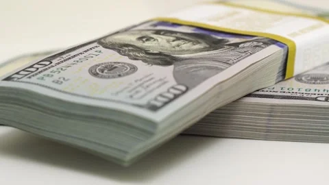 Stack of bank bundles with US dollars on a white background. Close-up shot of Stock Footage 245697457
