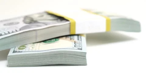 Stack of bank bundles with US dollars on a white background. Close-up shot of Stock Footage 245798188