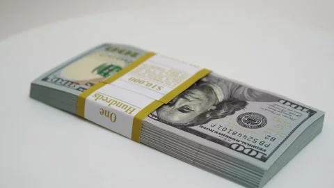 Stack of bank bundles with US dollars on a white background. Close-up shot of Stock Footage 246037081