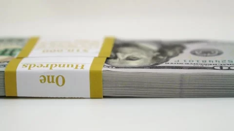 Stack of bank bundles with US dollars on a white background. Close-up shot of Stock Footage 246175084