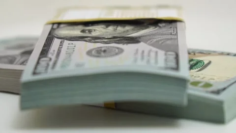 Stack of bank bundles with US dollars on a white background. Close-up shot of Stock Footage 246353450