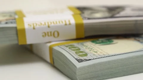 Stack of bank bundles with US dollars on a white background. Close-up shot of Stock Footage 246473995