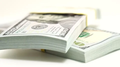 Stack of bank bundles with US dollars on a white background. Close-up shot of Stock Footage 246906606