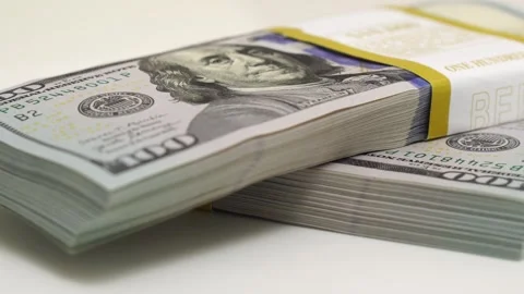 Stack of bank bundles with US dollars on a white background. Close-up shot of Stock Footage 247174187