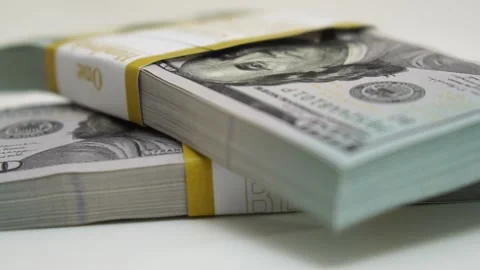 Stack of bank bundles with US dollars on a white background. Close-up shot of Stock Footage 247244269