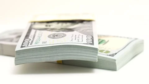 Stack of bank bundles with US dollars on a white background. Close-up shot of Stock Footage 247312925