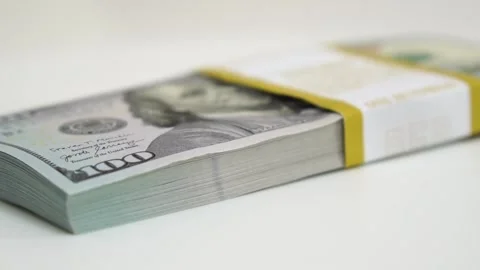 Stack of bank bundles with US dollars on a white background. Close-up shot of Stock Footage 247355732
