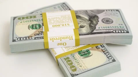 Stack of bank bundles with US dollars on a white background. Close-up shot of Stock Footage 247392821