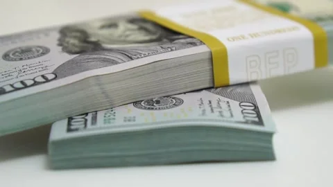 Stack of bank bundles with US dollars on a white background. Close-up shot of Stock Footage 247434033