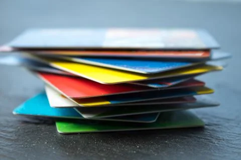 Stack of bank cards on a black background. black friday, sale Stock Photos