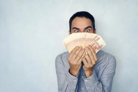 Stack of banknotes five thousand russian rubles in man hand on blue backgro.. Stockfoto's
