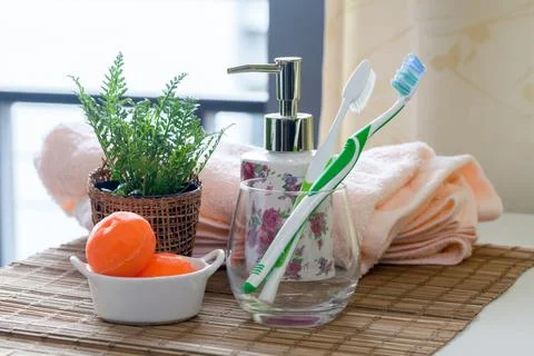 Stack of bath towels with toothbrushes on table Stock Photos