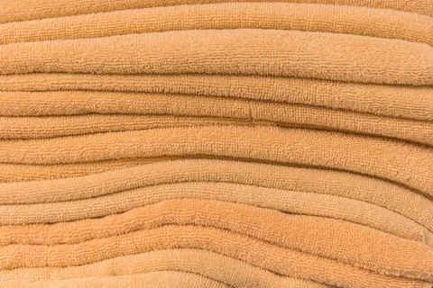 Stack of bath towels on wooden table Stock Photos