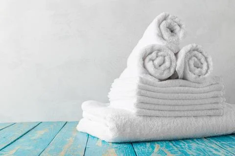 Stack of bath towels on wooden table with copy space Stock Photos