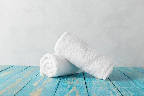 Stack of bath towels on wooden table with copy space Stock Photos