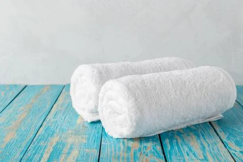 Stack of bath towels on wooden table with copy space 스톡 사진