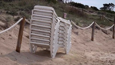 Stack of beach chairs Stock Footage 98386907