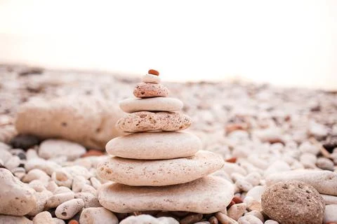 Stack of beach pebble stones at sea shore outdoors. Summer vacation season. B Stock-Fotos