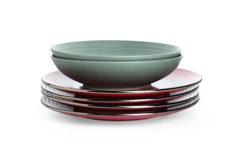 Stack of beautiful ceramic plates and bowls isolated on white Stock Photos
