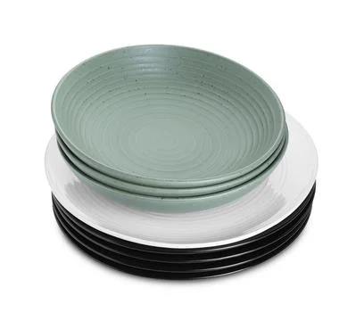 Stack of beautiful ceramic plates and bowls isolated on white Stock Photos