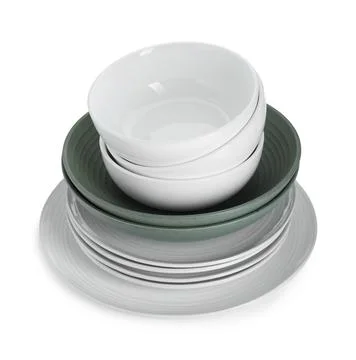 Stack of beautiful ceramic plates and bowls isolated on white Stock Photos