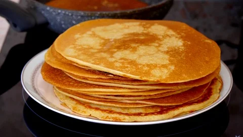 A stack of beautiful ruddy golden yellow Russian traditional pancakes on a ro Stock Footage 118213667