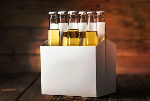 Stack of beer in a white box against a wooden background, with copy space Stock Photos