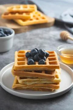 Stack of belgian waffles with blueberry and honey for breakfast. Delicious ho Stock-Fotos