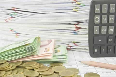 Stack bill gold coins brown pencil and calculator Stock Photos