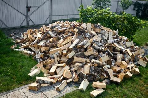 Stack of birch firewood with hand chopping block. Chopped firewood for wint.. Stock Photos