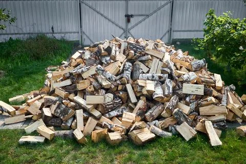 Stack of birch firewood with hand chopping block. Chopped firewood for wint.. Stock Photos