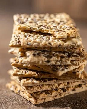 Stack of biscuit crackers with sunflowers seeds and sesame, vertical, close up Stock Photos